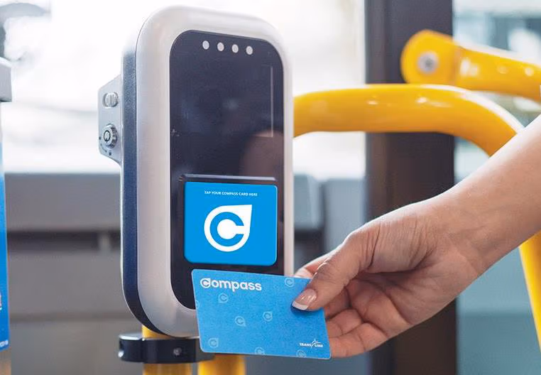 Compass Card being tapped by a card reader