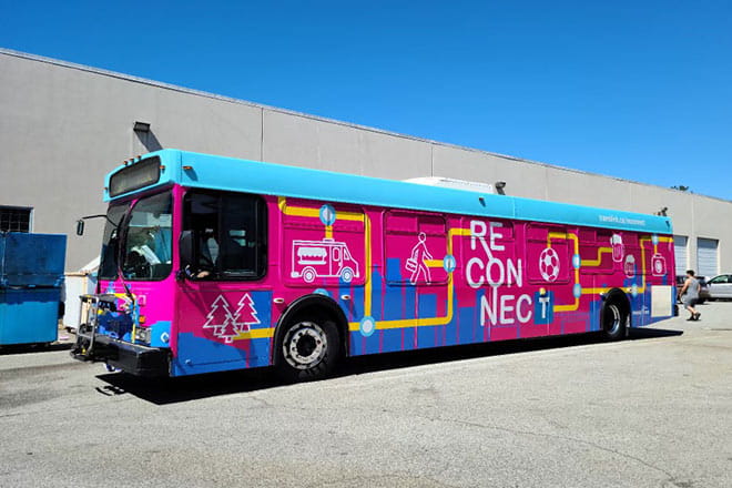 The TransLink Reconnect bus in bright pink