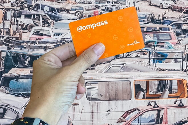 Compass Card in front of old vehicles