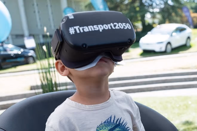 Child with Transport 2050 goggles at the PNE exhibit