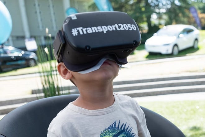 Child with Transport 2050 goggles at the PNE exhibit