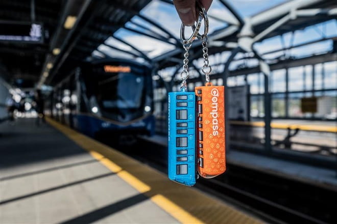 Compass Mini-Train in front of a SkyTrain