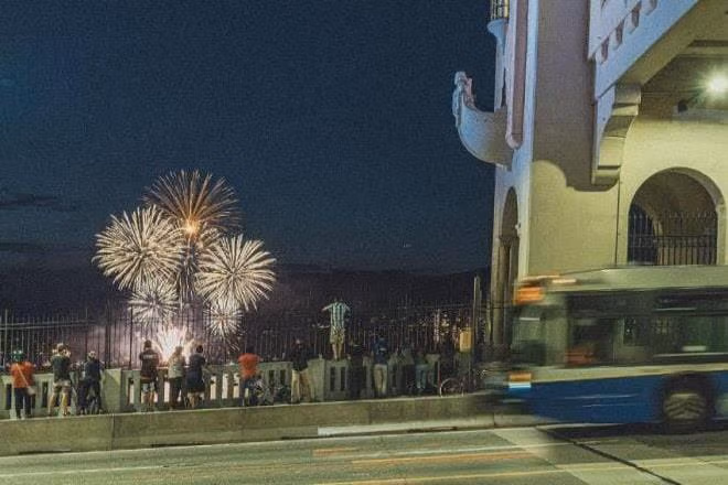 People watching the Celebration of Light fireworks from the Burrard Street Bridge