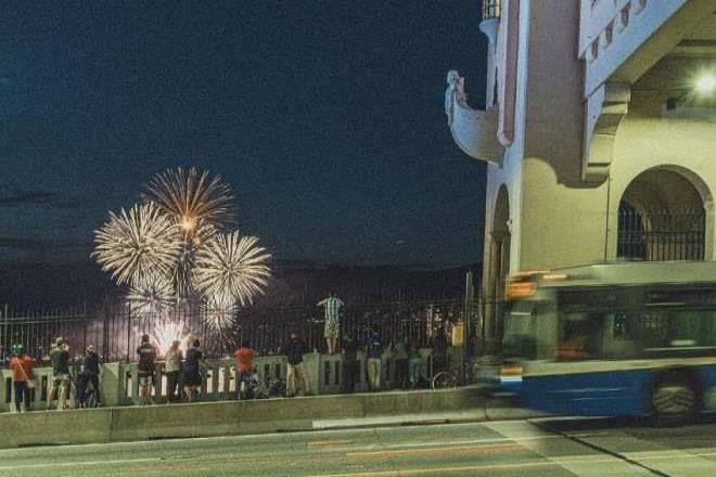 People watching the Celebration of Light fireworks from the Burrard Street Bridge