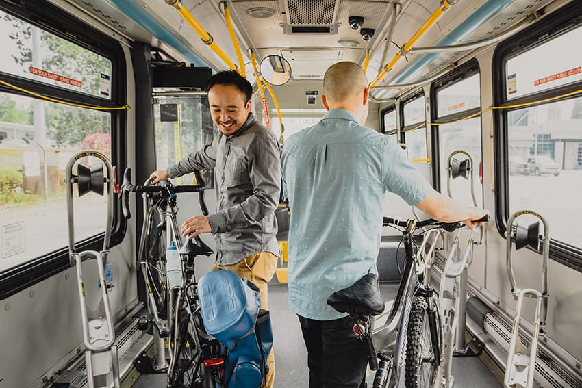 Two men parking their bikes on the interior Bike Bus bike racks