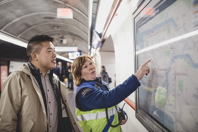 SkyTrain attendant and customer