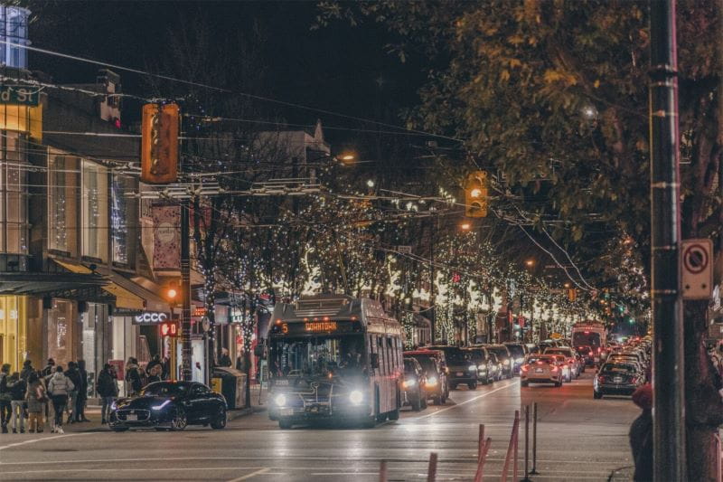 Route 5 bus travelling downtown at night, pedestrians crowding sidewalks