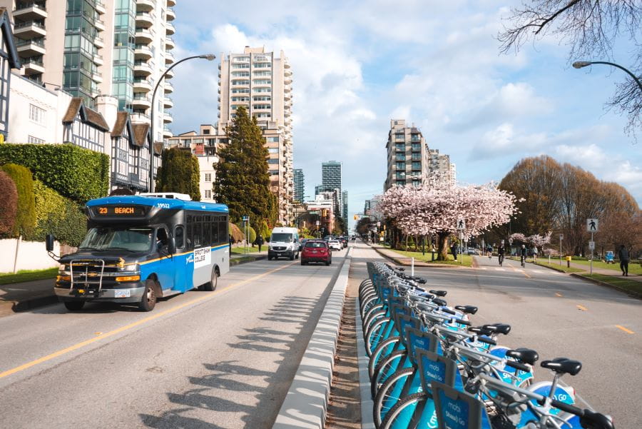 Route 23 community shuttle driving past Mobi bike rack on Beach Ave.