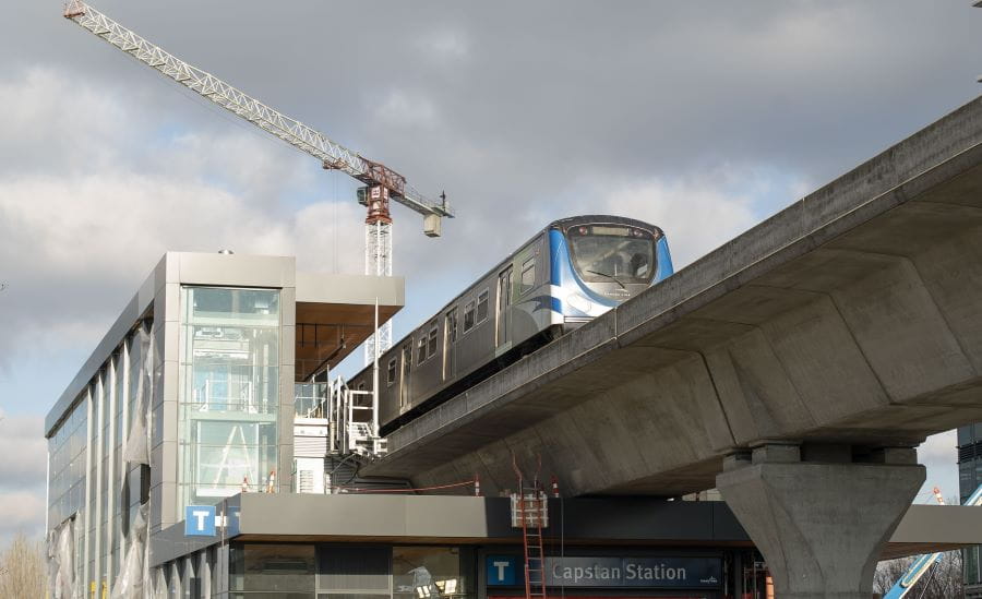 View of Canada Line car passing through Capstan Station under construction with crane in background