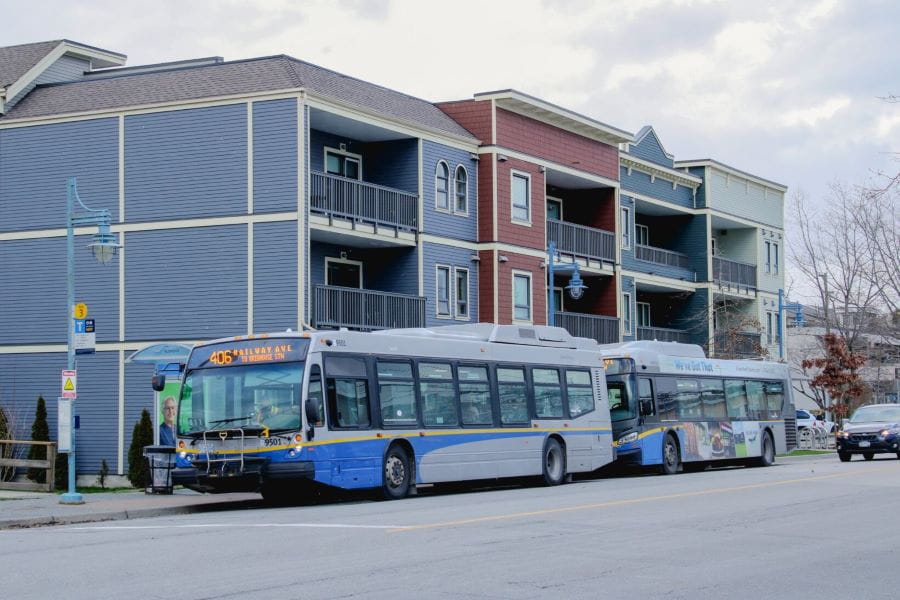 Buses in front of businesses at Steveston Bus Exchange