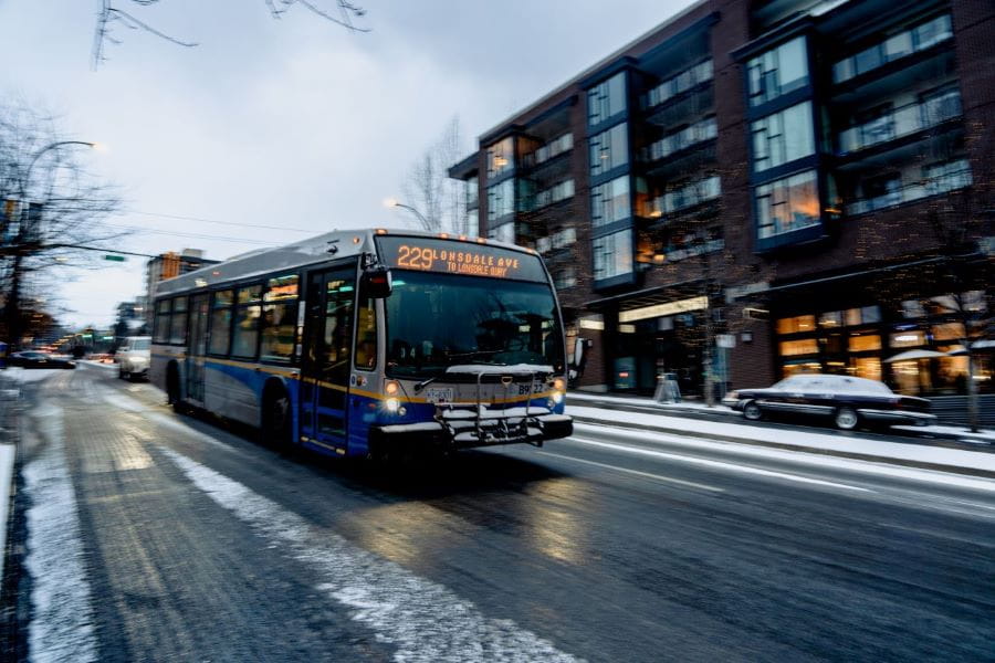 North Vancouver bus driving down slushy street