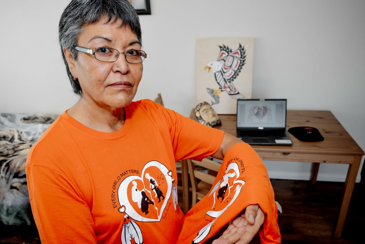 Taltan Tlingit Nation, Wolf Clan artist Rose Tashoots proudly wearing and displaying the orange shirt she helped to design