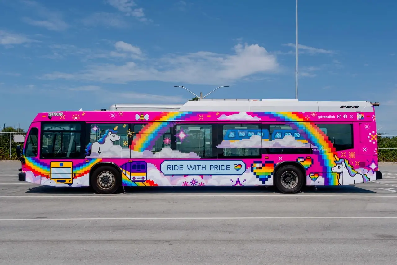 The 2025 PrideBus, playfully decorated in a 16-bit style, with images of other transit vehicles, rainbows, unicorns, and bees decorating the bus