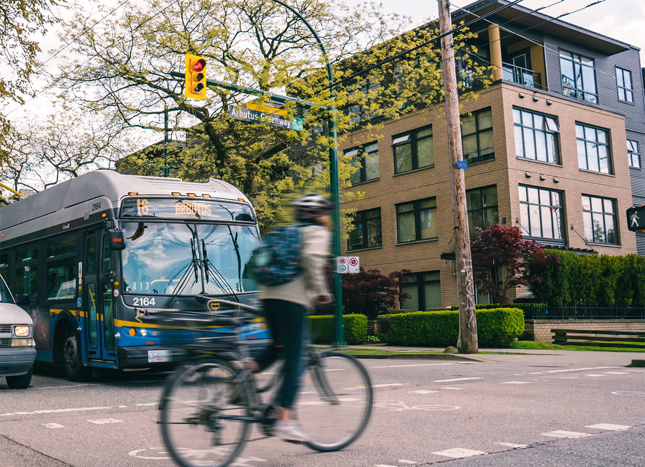 Cyclist passing in front of bus stopped at intersection