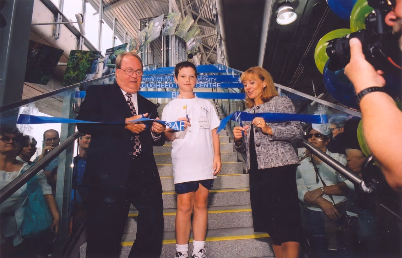 Politicians surround a young child as they cut the ribbon to officially open the Millennium Line during the opening ceremony
