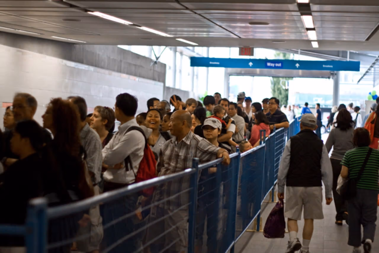 Crowds of people are waiting to enter Broadway-City Hall Station during the opening day of the Canada Line in 2009