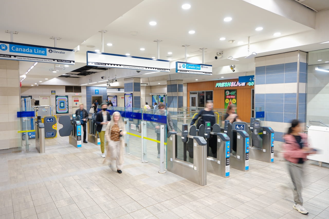 Customers move through newly installed fare gates at Yaletown–Roundhouse Station on the Canada Line, improving accessibility and customer flow during busy periods and major events.