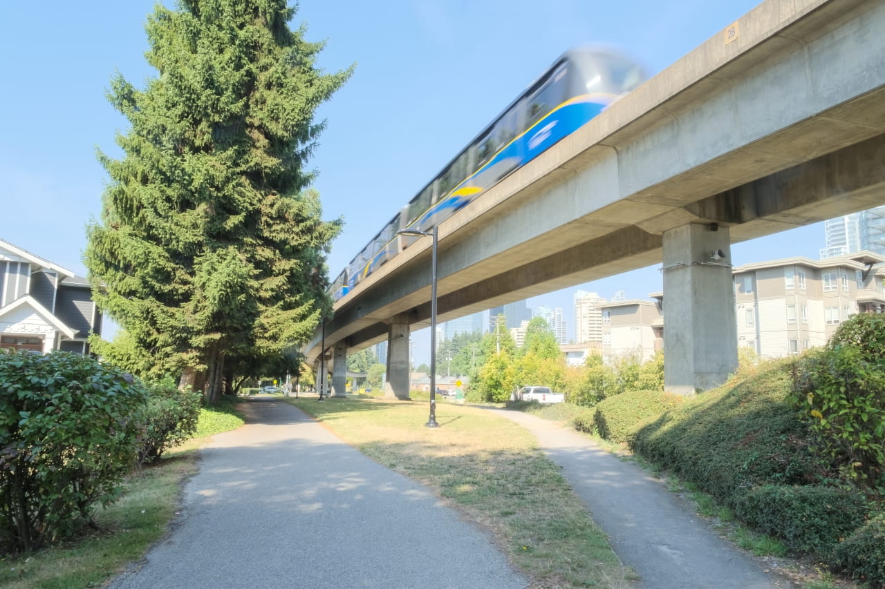 SkyTrain travelling above the BC Parkway in Burnaby, where upgrades will improve walking and cycling infrastructure